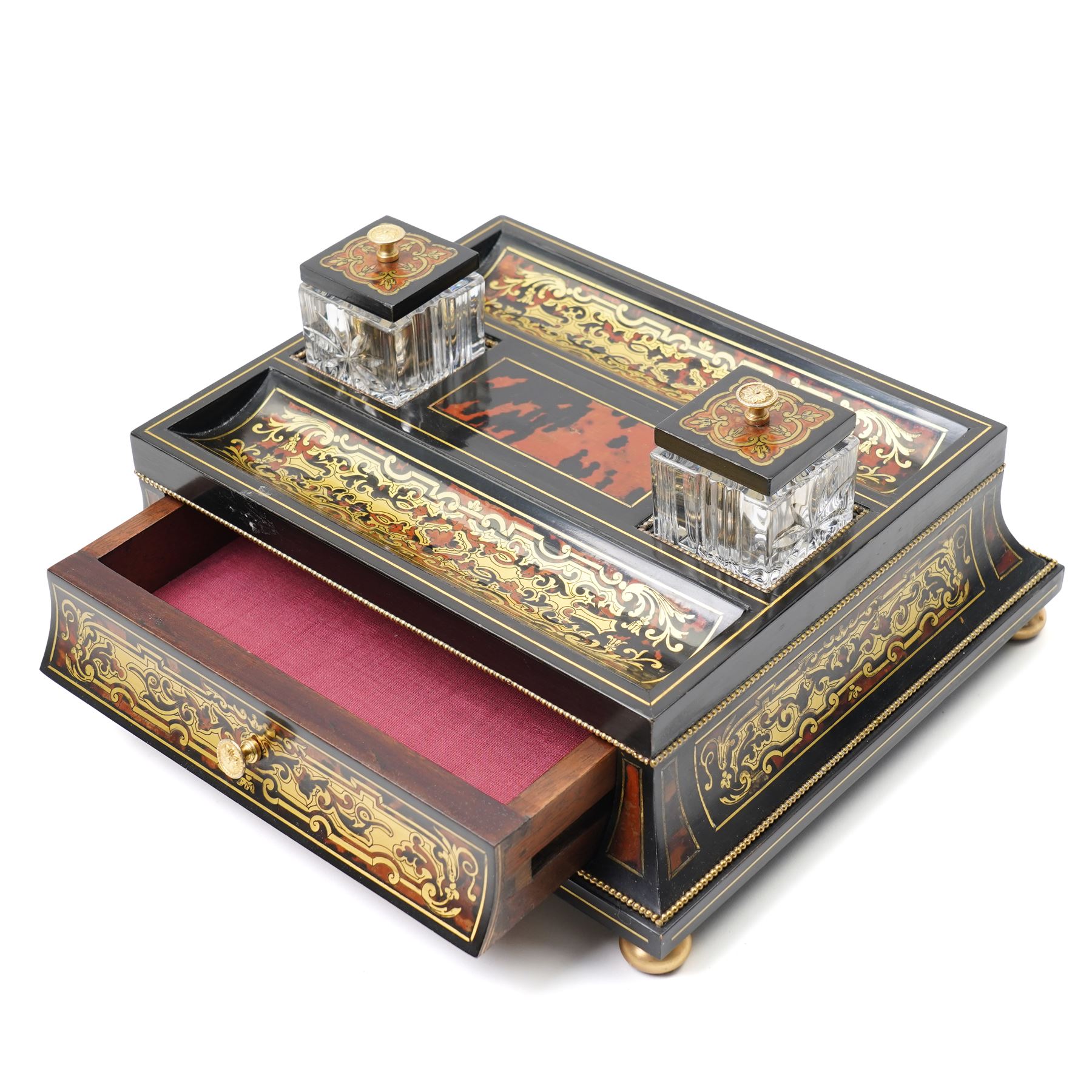 Mid 19th century Boulle inkstand in cut brass and tortoiseshell with beaded decoration with two pen trays and two inkwells on a single drawer base and compressed bun feet W32cm 