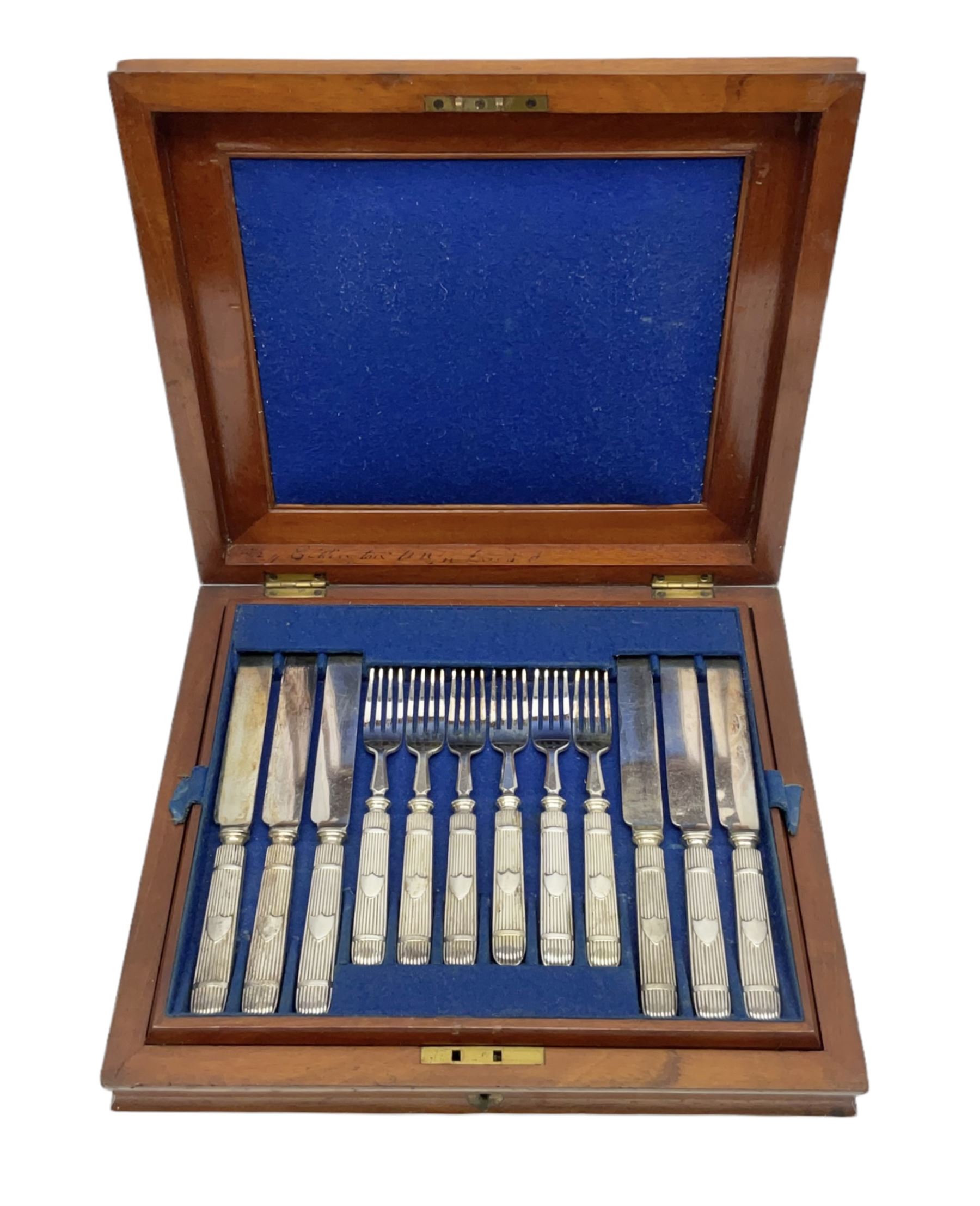 Victorian silver plated dessert set by Elkington & Co for twelve place settings, each reeded handle with vacant cartouche, each with Elkington & Co mark, date letter for 1861, and registration lozenge, contained within a mahogany case with vacant brass cartouche to the hinged cover, opening to reveal a Royal blue baize lined interior with removable tray, case H6cm W29.5cm D26.5cm