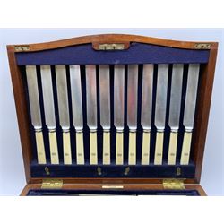 Late 19th/early 20th century composite canteen of silver flatware, contained within an early 20th century mahogany serpentine fronted case with twin drop carry handles, and hinged cover with boxwood stringing and central inlaid shell motif, above a single drawer with twin ring handles and Wellington style locking system, the cover and drawer opening to reveal plaque for Spink & Sons Ltd London, and fitted interior containing ivory handled knives, ivory handled carving set, and silver Hanoverian and Old English pattern cutlery, each with engraved monogram to terminal, hallmarked London, makers Spink & Son (John Marshall Spink), Goldsmiths & Silversmiths Co, and Chawner & Co (George William Adams), various dates ranging 1880-1923, gross weighable silver 92.59 ozt (2880 grams)