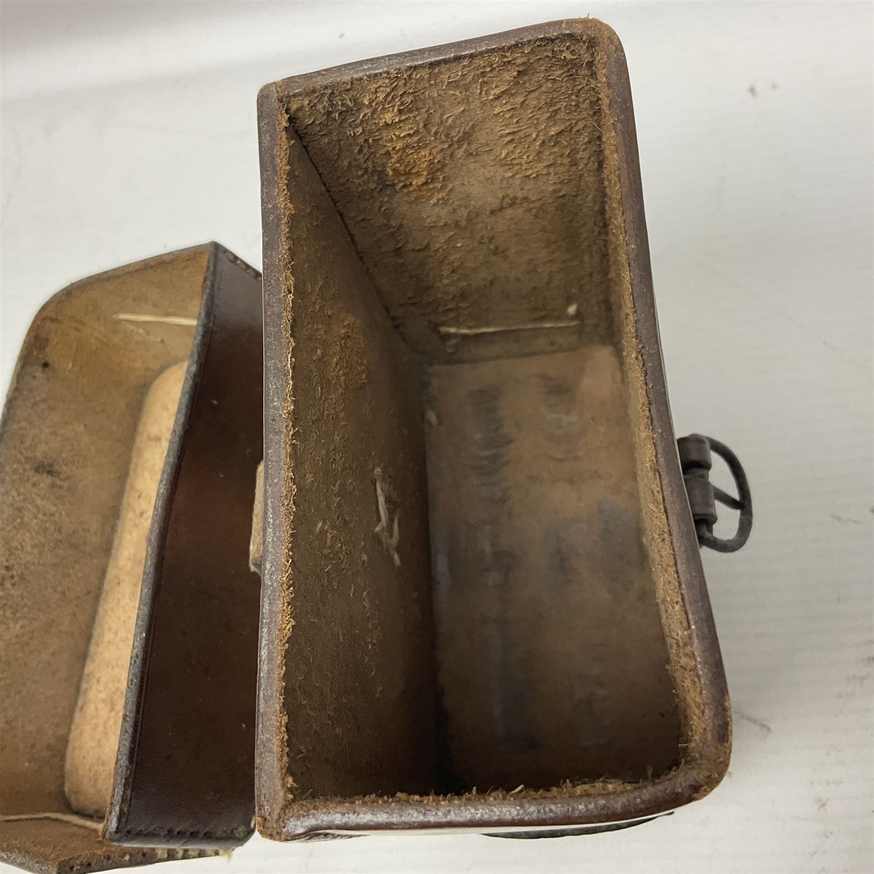 WWII British marching compass, the black lacquered brass case inscribed T.G.Co.Ltd. No.B100228 (broad arrow) 1941 Mk.III; and a ship's brass cased clinometer, the silvered dial marked R(arrow)L, D9cm; in leather carrying case (2)