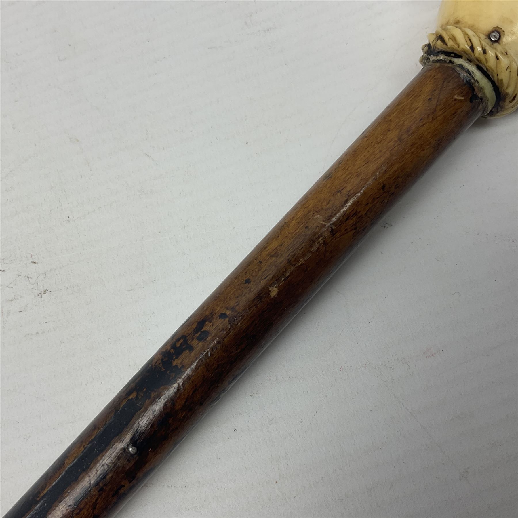 19th century malacca walking cane with scrimshaw handled in the form of a clenched fist holding a scroll, H86cm 