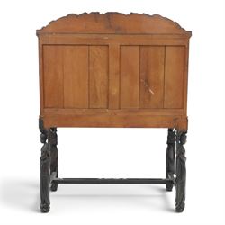 Early 20th century Chinese export carved hardwood writing bureau, the sloped fall front deeply carved with a narrative figural scene beneath pine and prunus trees, above a pair of rectangular carved panels, the shaped crest rail with entwined dragons, interior fitted with pigeonholes and a central drawer, on figural front supports with shaped stretcher