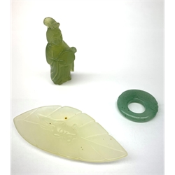 A small carved jade leaf detailed with a fish, L7.5cm, together with a carved jade pendant detailed with a fish, D3cm, and a small carved pendant modelled as a female figure, H5.5cm. (3). 