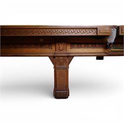 An outstanding bespoke late Victorian Aesthetic Movement golden oak full-sized snooker table of gothic influence, the rectangular slate bed covered in green baize within moulded rails and rounded pocket mounts, the protruding frame decorated with blind-fretwork frieze panels of Vitruvian scrolls and geometric ornament, over rails of repeating roundel carvings, raised on square chamfered and reeded supports with carved detail and panelled reserves, with further stylised brackets, stamped to the underside on all four edges R Anderson, serial number 4337
Viewing in situ near Tadcaster, please contact Chloe to arrange - 01904 393300