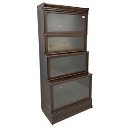 Globe Wernicke - early 20th century waterfall stacking library bookcase, four tiers with hinged and sliding glazed doors, with label inscribed 'The Globe-Wernicke Co. Ltd.'

