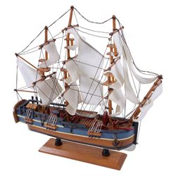 Three wooden model ships, comprising a single mast Schooner style pond yacht, a kit-built Viking longship and a model of HMS Endeavor, Schooner H117cm