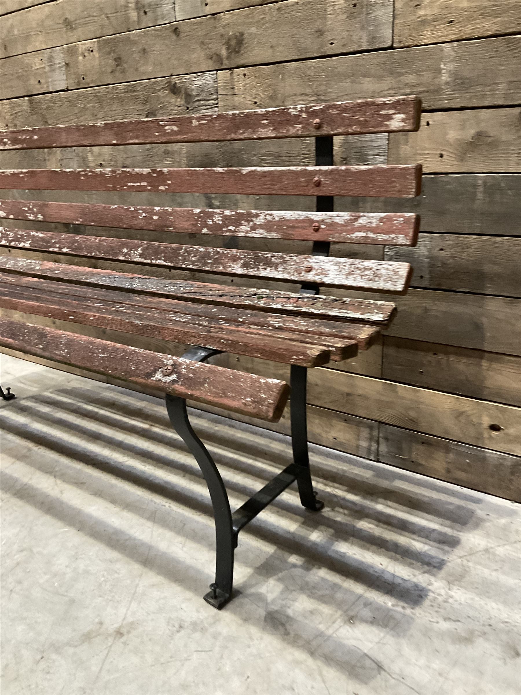 Wrought metal and wood slatted garden bench