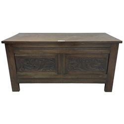 Early 20th century oak blanket box, hinged top over panelled front carved with scrolled acanthus leaves, moulded horizontal rails, on stile supports