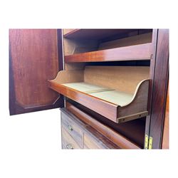 George III mahogany linen press cupboard, projecting moulded cornice over two panelled doors, the interior fitted with two slides and shelf, two short and two long drawers below, shaped apron over bracket feet 