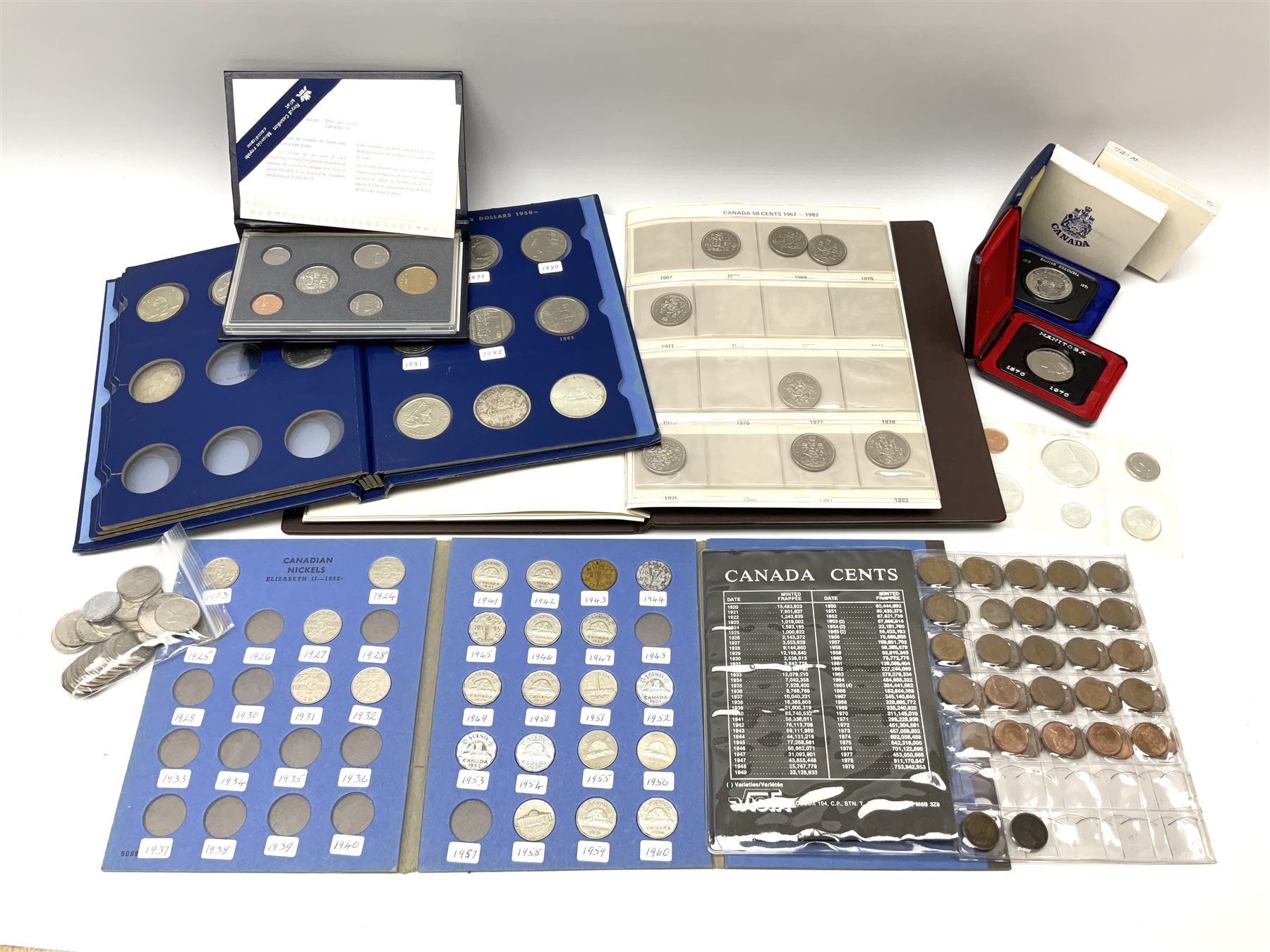 Mostly Canadian coins including 1967 six coin set, various Canadian 50 cent coins, various nickels, Royal Canadian Mint 1990 specimen coin set in blue folder with outer sleeve, various Canadian dollars etc, in folders and loose