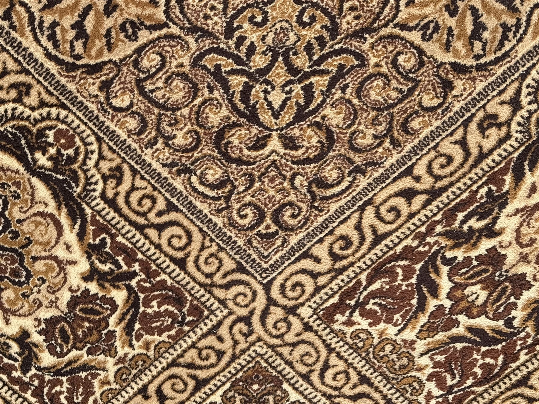 Persian Tabriz ivory ground rug, the field centred by a shaped floral medallion with swirling spandrels, richly decorated with foliate motifs, the broad border with matching cartouches and palmettes, within multiple guard stripes