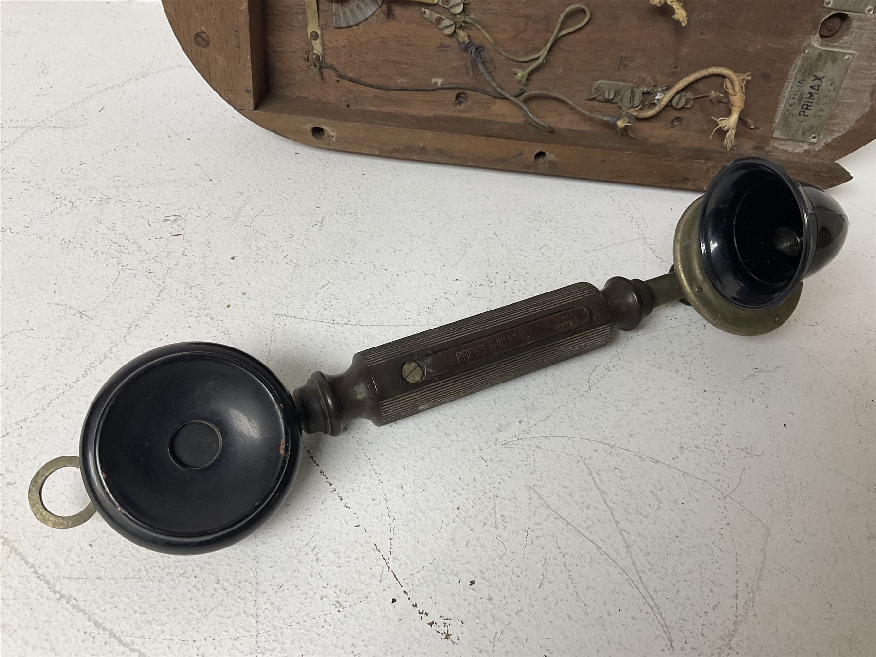 Two Hunningscone patent wall mounting telephones in walnut casing, together with Sterling Telephone & Electric Co. Ltd early wall-mounted telephone 'Primax' and one other 