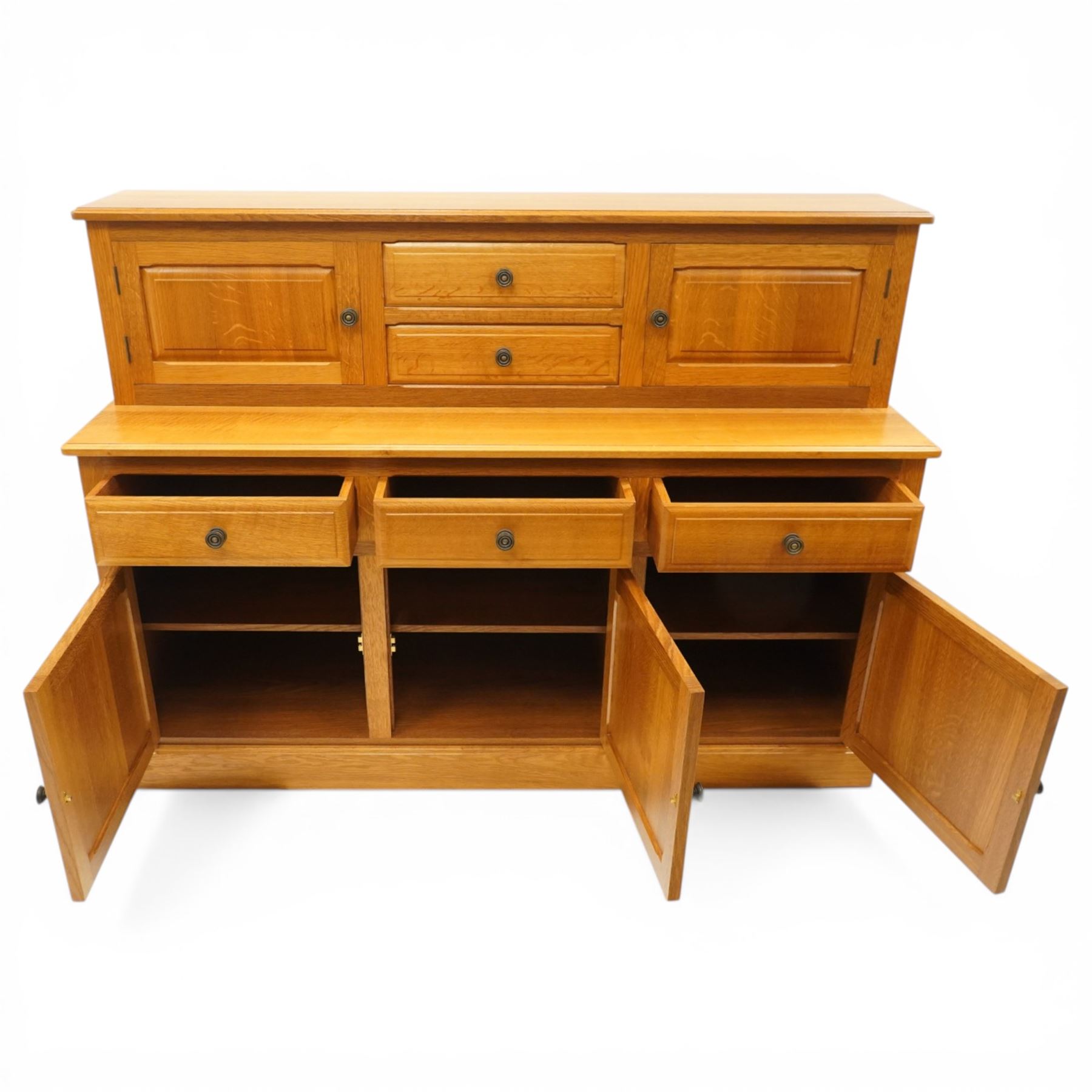 Knightman - Yorkshire oak dresser, the upper section fitted with two drawers flanked by two hutch cupboards, rectangular top over three drawers and fielded panelled cupboard, on skirted base, carved with knight signature, by Horcace Knight of Thirsk