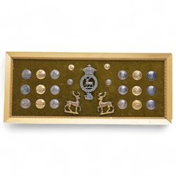 Collection of twenty two 19th century livery buttons with stag motif, badge with stag and St George design and two gilt stag  badges, framed 18cm x 44cm 