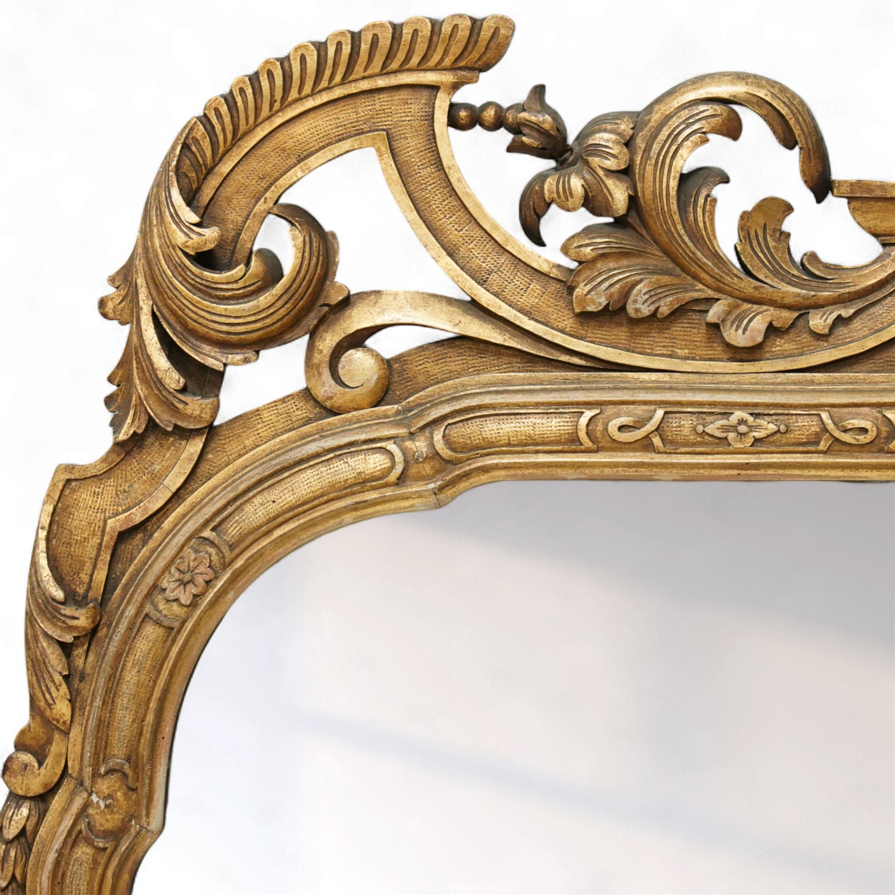 Georgian design giltwood overmantel mirror, arched rectangular plate within a moulded frame, the cresting carved with scrolling acanthus and shell motifs, trailing foliate decoration continuing to the shoulders and lower apron