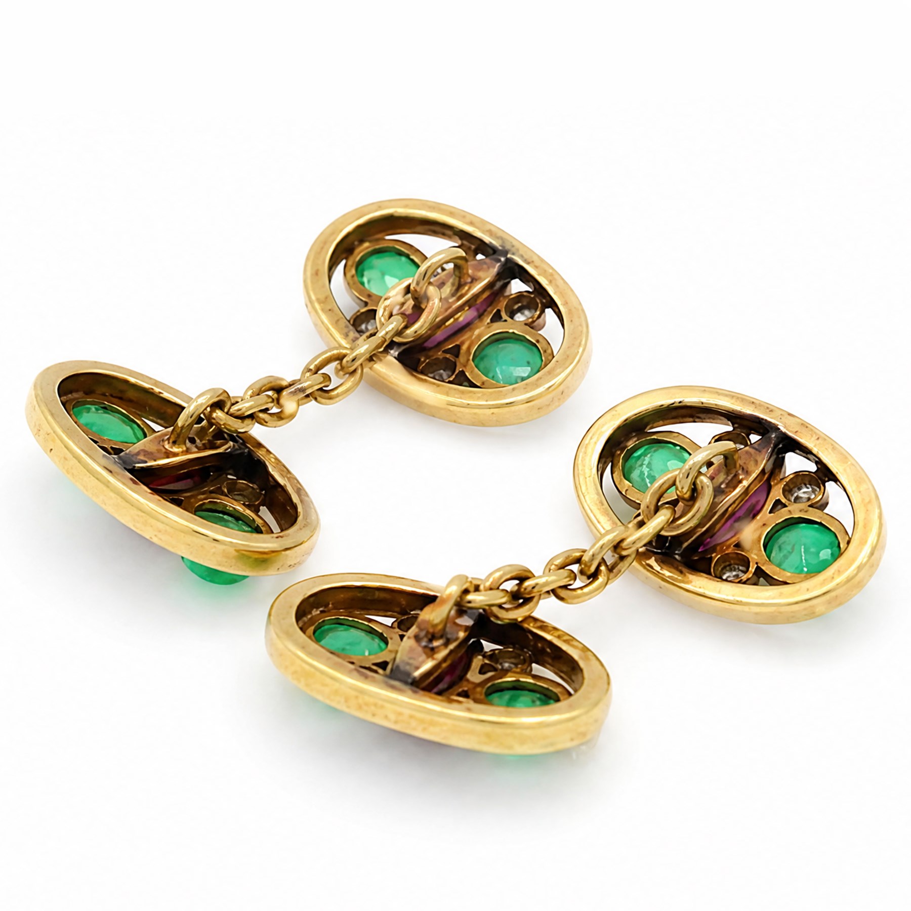 Pair of 18ct gold ruby, emerald and diamond cufflinks, each head openwork set with two oval cabochon cut emeralds, four milgrain set round cut diamonds and a marquise cut ruby  