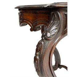 19th century Irish rosewood centre table, the shaped and moulded top over shaped apron carved with scrolled foliage, on serpentine supports carved with bell flowers, the supports united by anthemion carved finial and s-scroll x-framed stretchers