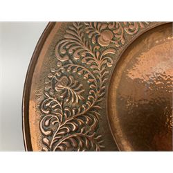 Arts and Crafts Keswick School of Industrial Arts copper charger, decorated with planished centre and repousse scrolling foliate tendrils to rim, D44cm