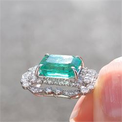 Platinum Colombian emerald and diamond pendant necklace, single octagonal cut emerald of 7.38 carat, surrounded by round cut diamonds in a fancy milgrain pierced design setting, stamped Pt 950, on a trace link chain necklace, total diamond weight 1.14 carat, with GCS certificate