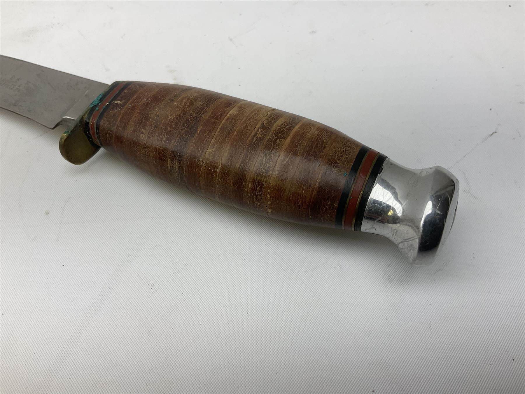 Graduated set of three Bowie knives by J. Nowill & Sons Sheffield England Est. AD1700, each with steel blade, brass cross-piece, stacked leather type grip and alloy pommel; largest blade 13cm and smallest 7.5cm; each in leather sheath (3)