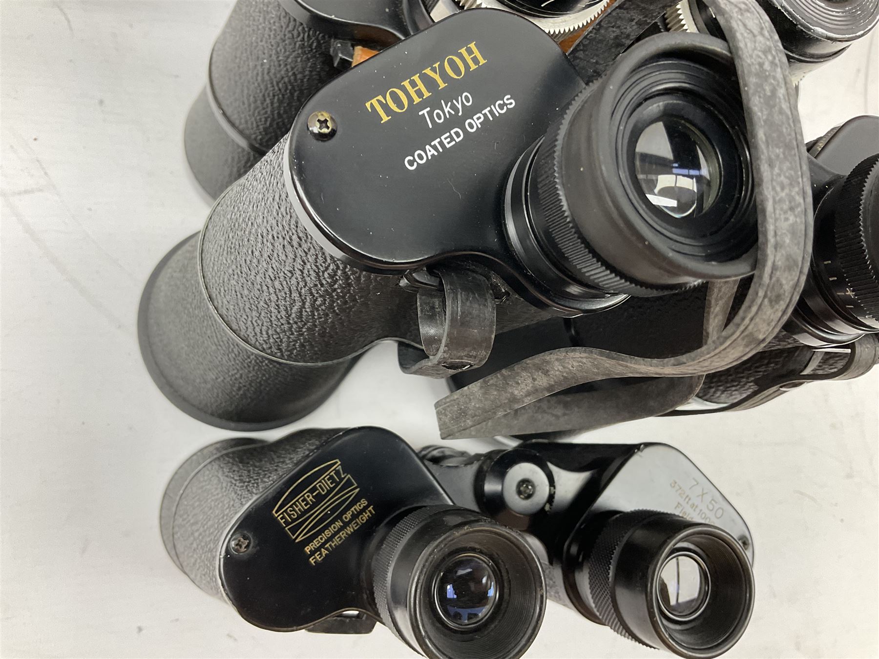 Nine cased pairs of binoculars, to include Tohyoh 22x70, Greenkat 7x- 12x50, Chinon, Fisher-Dietz 7x50, etc