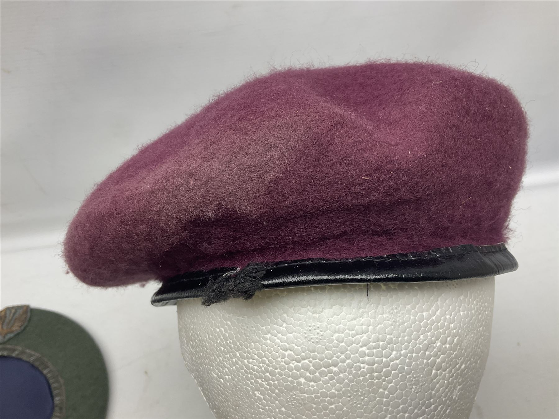 Four paratrooper berets - Russian, Italian, British and Foreign Legion; all with badges (4)
