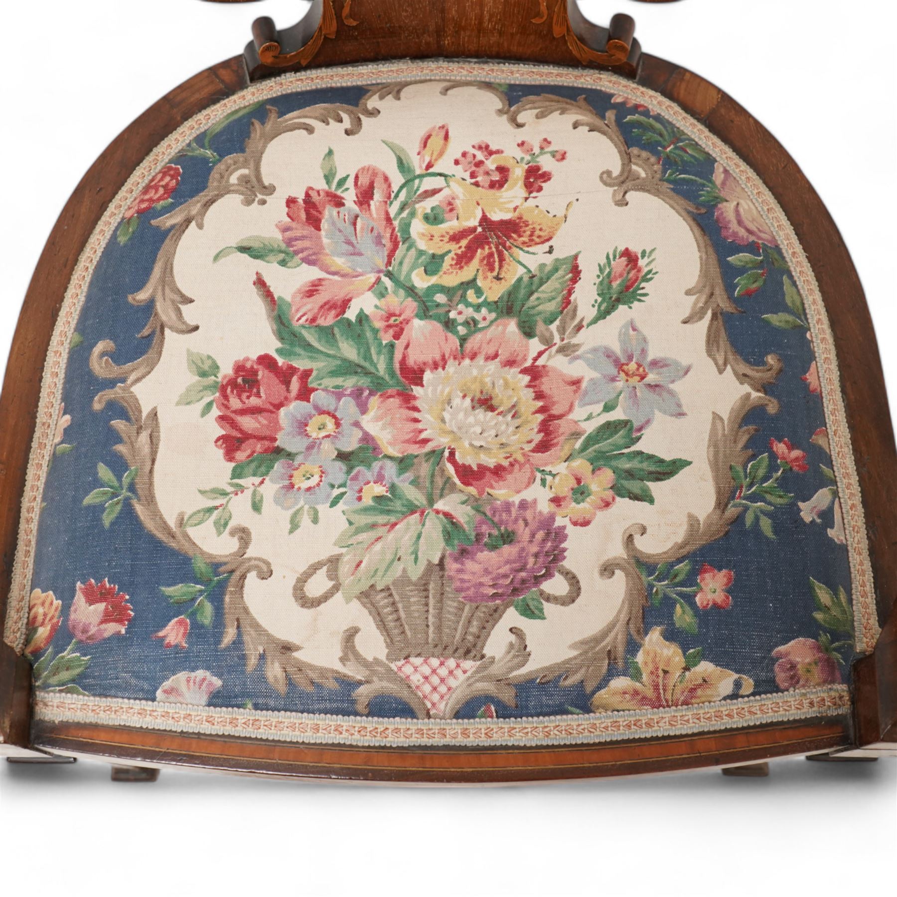 Edwardian inlaid mahogany elbow chair, satinwood banded cresting rail decorated with acanthus leaf carving, open pierced and interlaced back inlaid with curled foliage, floral pattern fabric upholstered seat, on square tapering supports with compressed spade feet
