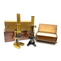 Carl Zeiss Jena brass monocular microscope, lacking all lenses, serial no.5822, in fitted mahogany box H26.5cm; another unmarked brass and black enamelled monocular microscope in fitted case with quantity of slides; and a pine microscope slide box of oblong fall front form with twelve removable trays (unstocked) (3)