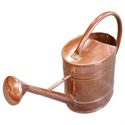 19th century copper watering can, with a looping handle and a rose to the end of the spout