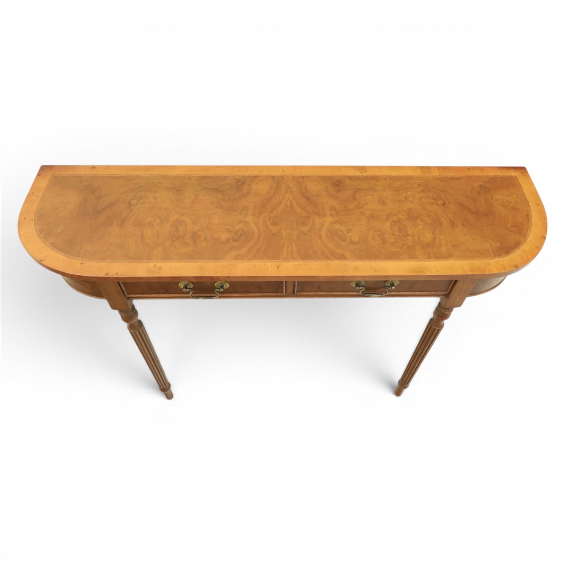 Traditional design walnut D-end hall table, figured top and sides, two frieze drawers with brass handles raised on fluted and turned supports