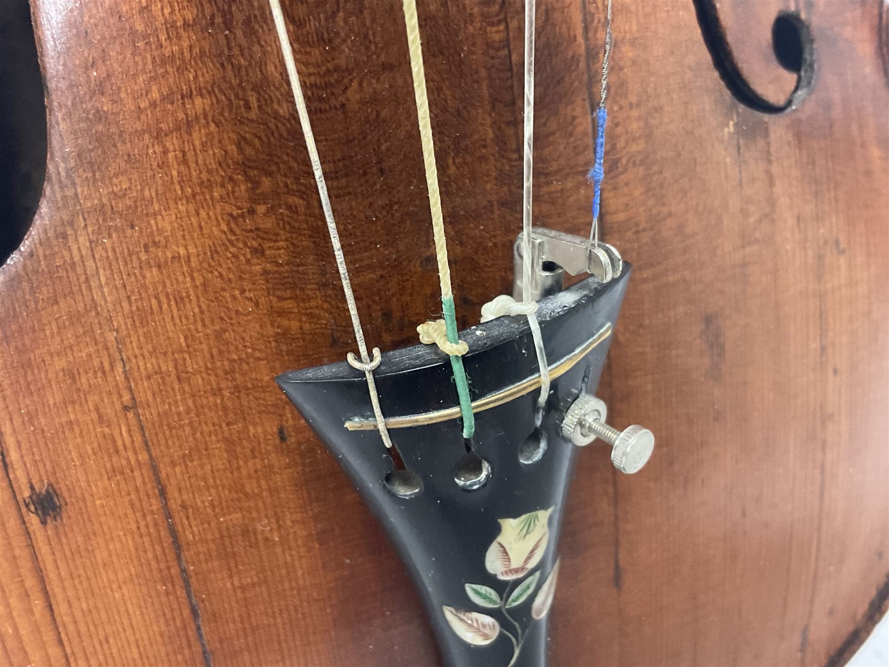 19th century full sized violin in a later hard case, decorative mother of pearl inlay to the tail piece Overall length 60cm No bow