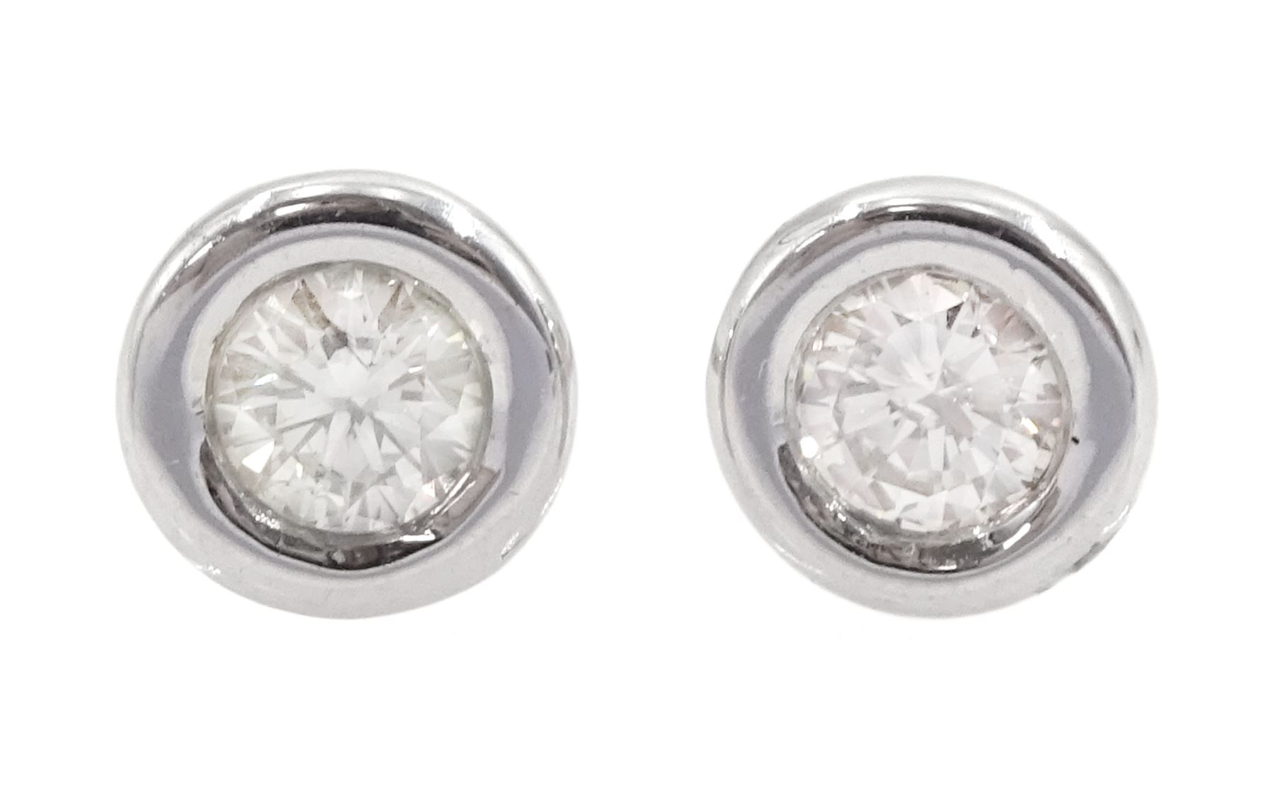 Pair of 14ct white gold bezel set round brilliant cut diamond stud earrings, total diamond weight approx 0.30 carat