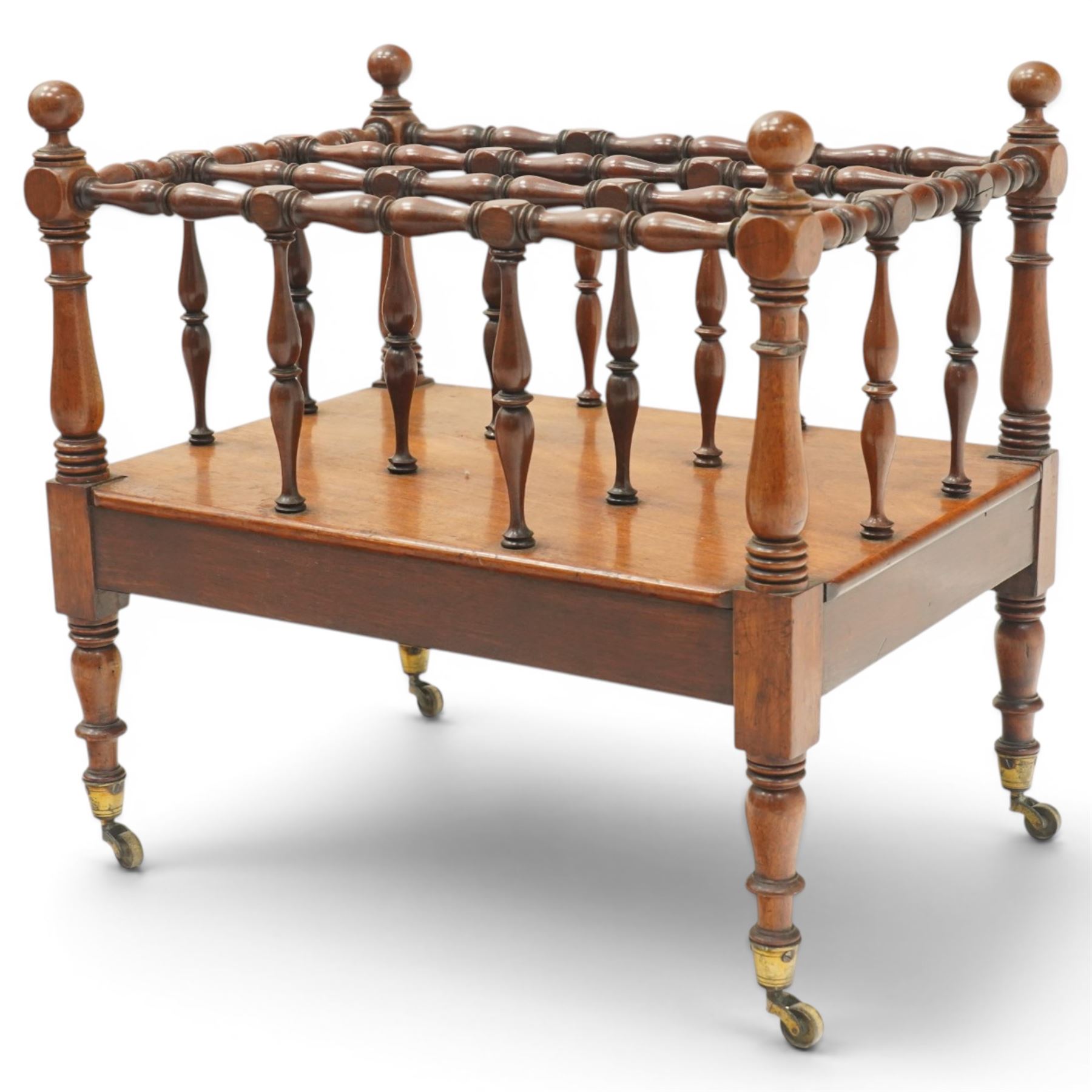 Victorian mahogany canterbury, four division top with bobbin turned rails and spindle uprights, rectangular base with moulded edge, on turned corner supports with brass castors