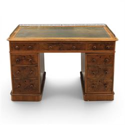 Victorian figured walnut twin pedestal desk, brass galleried top with inset tooled green leather writing surface, above three frieze drawers, raised on two pedestals with three drawers, on plinth bases above castors