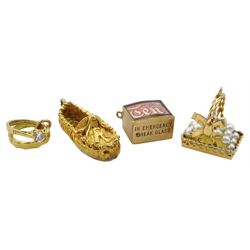 Three 9ct gold charm/pendants including ten pound note, slipper and engagement rings and a gold pearl basket charm/pendant