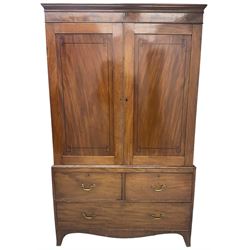 19th century mahogany linen press, projecting moulded cornice over figured frieze, enclosed by two panelled doors with geometric stringing, fitted with two short and one long cock-beaded drawers, on shaped apron and splayed bracket feet