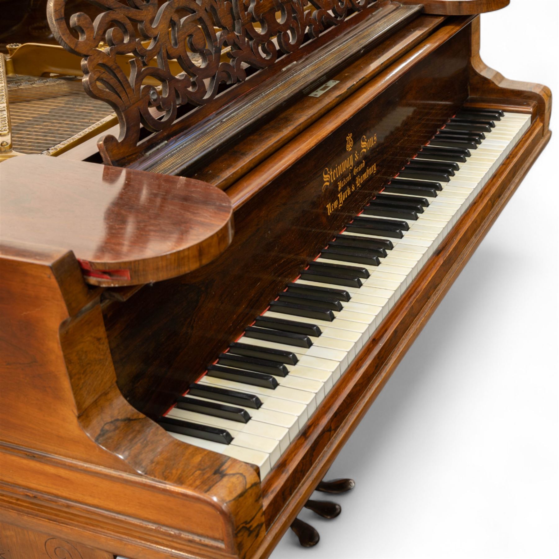 Steinway & Son, New York & Hamburg- Model B, overstrung Drawing Room Grand Piano in a rosewood case, Serial No 87297 (1896/7), with 85 ivory covered and ebony keys A0-A7(7 octaves) with an adjustable fretted music desk, brass fittings and pedals, Steinway “Fireplug” straight columnar and fluted legs with roller castors and conforming lyre, duplex stringing with agraffs, bass strings copper wound with a steel core, steel tuning pins, original Steinway action, hammers, keys, felts, and dampers, with una-corda, sostenuto and sustain pedals, Overstrung iron frame detailing numerous Steinway patents, awards, and features. Tuned to Concert pitch (A=440). 
With an adjustable single stool. 

This item has been registered for sale under Section 10 of the APHA Ivory Act HLB1KY67