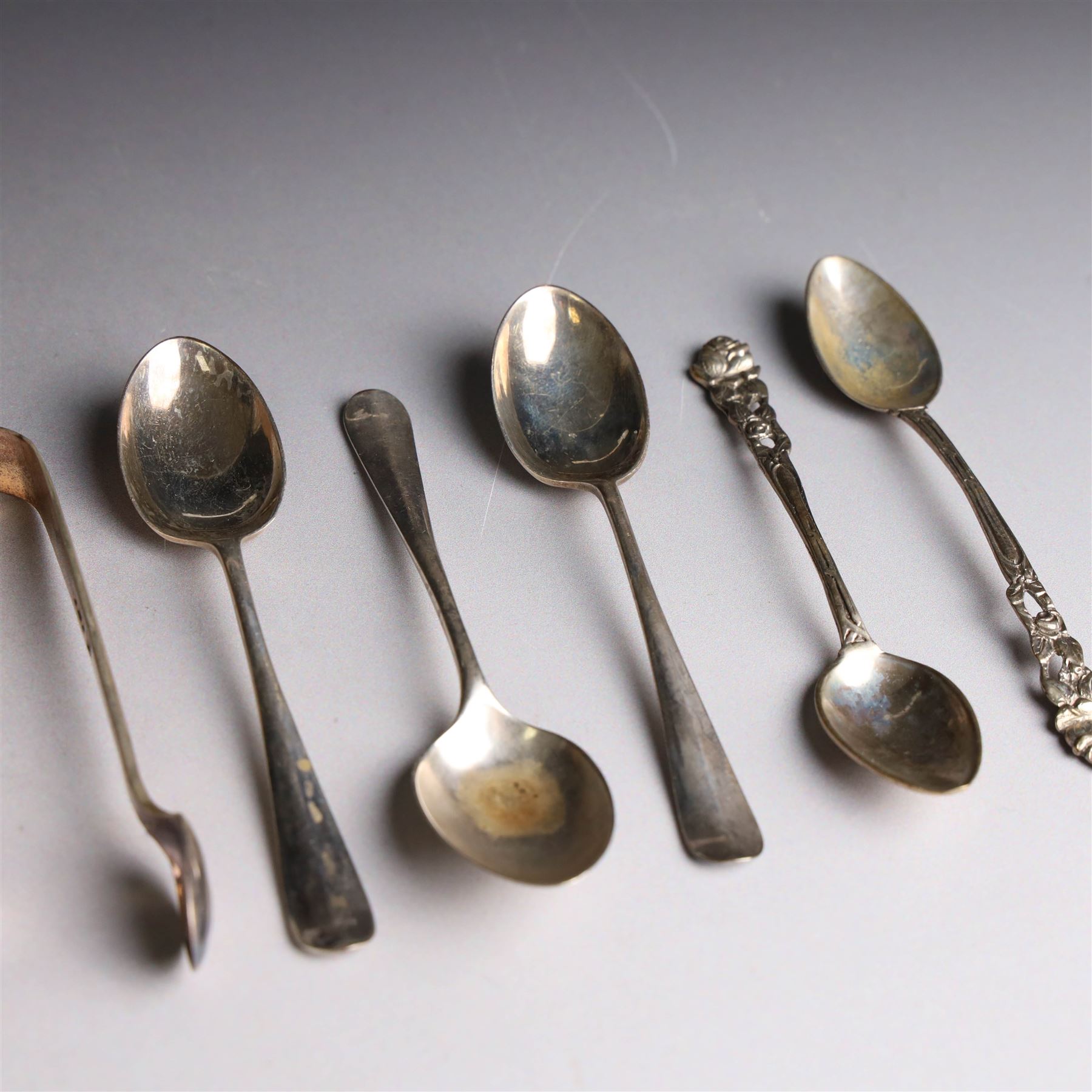 Set of six continental 800 silver coffee spoons with pierced rose design finials, stamped 800 verso, together with a cased set of six teaspoons and sugar tongs, with rattail bowls and engraved initials verso, hallmarked Cooper Brothers & Sons Ltd, Sheffield 1912, 