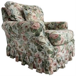 Traditional shaped armchair, with loose cushions and scatter cushion upholstered in loose floral cover, on castors, calico upholstered cover underneath 