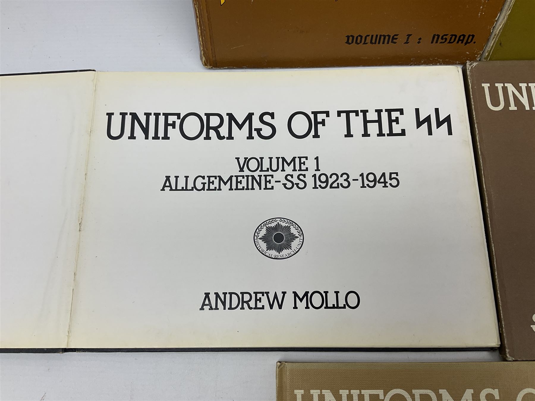 Military Collectors Service: set of three books on WWII German uniforms and badges; and Mollo Andrew: Uniforms of the SS. Volumes 1,4,5,6 & 7 (8)