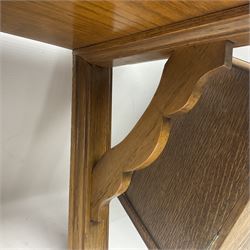 Early 20th century oak smokers cabinet, with brass shield shaped mounts, opening to reveal a compartmentalised interior with three drawers, pipe rack and tobacco jar, together with a small wooden shelf, smokers cabinet H28.5cm