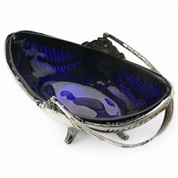 German standard 800 silver oval centrepiece with pierced sides, trailing harebells and swing handle, blue glass liner on splay feet L29cm Maker Wilhelm Binder