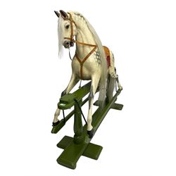 Attributed to F. H. Ayres - early 20th century carved wooden dapple grey rocking horse, with leather saddle and tack, with glass eyes, on green painted trestle base with turned column supports