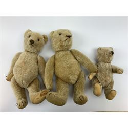 Three 1950s German teddy bears including blonde mohair, possibly Steiff, with swivel jointed head, glass eyes, vertically stitched nose and mouth and jointed limbs with felt paw pads H13