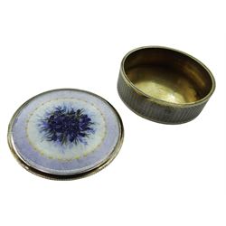 Swiss silver and enamel box and cover, of circular form, the body with engine turned decoration, the removable enamelled cover decorated with a spray of purple flowers within a lilac border, the interior stamped FBE Geneve 935, D5cm 