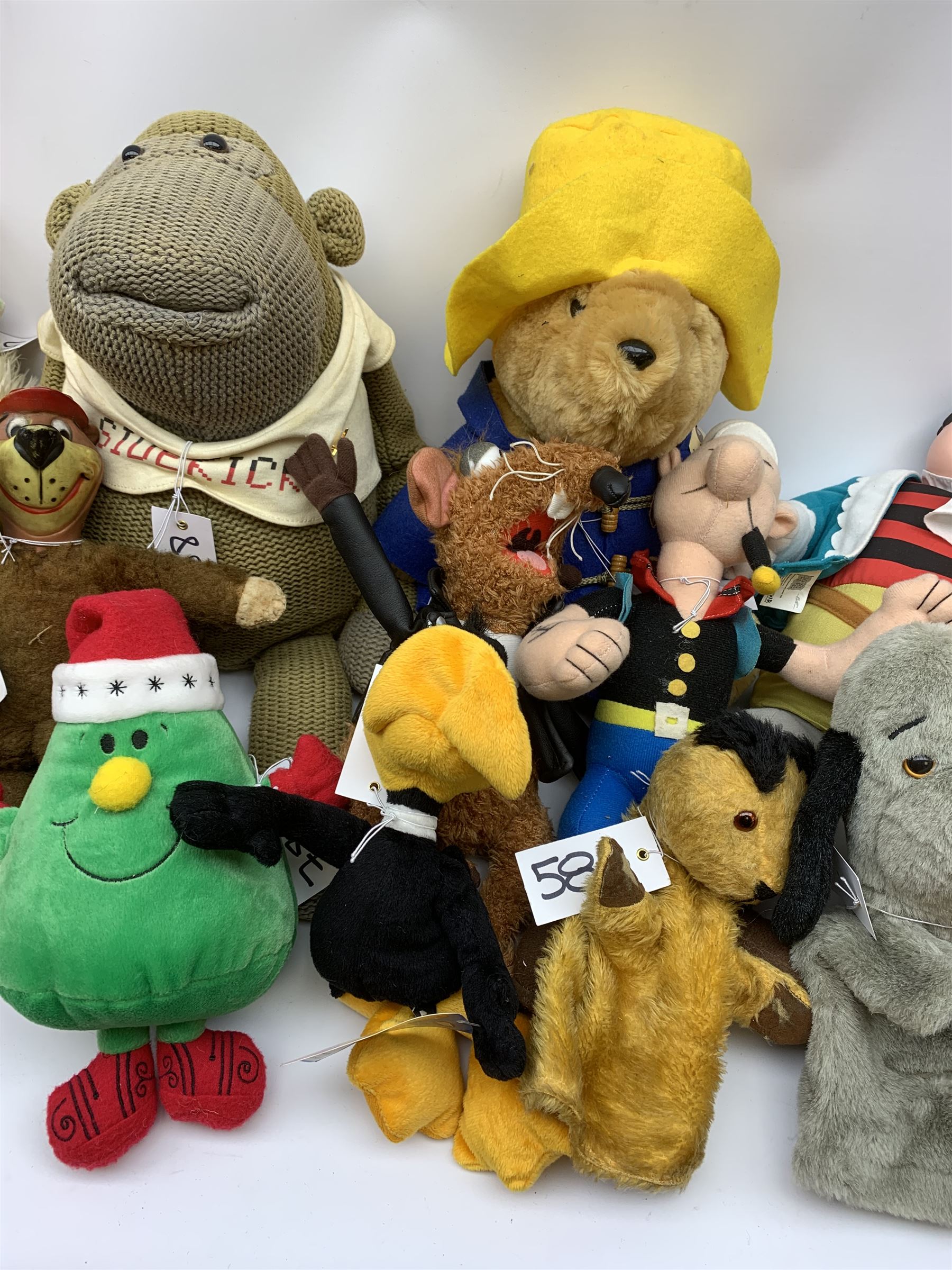 Twenty-one TV and film related and promotional soft toys including Sooty and Sweep hand puppets, Captain Pugwash, Muppets, Yogi Bear, Popeye, Paddington Bear, Zippy, Roland Rat etc