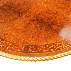 Arthur Brett & Sons - late 20th century twin pedestal dining table in the Second Empire style, the oval Amboyna burl veneered top, bordered with tulipwood crossbanding and delicate floral marquetry inlay, and rosewood crossbanded outer border within gilt gadrooned edge, over two mahogany triform pedestal bases with rosewood crossbanding and decorated with neoclassical marquetry of tied ribbons, leafy sprays, and scrolling acanthus decoration, raised on carved and gilded lion paw terminals on plinth bases, underside with maker's label