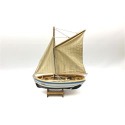 Wooden model of RMS Titanic, on a fixed black stand bearing plaque inscribed 'Titanic 1912', L54cm, H22cm, together with model of a sloop, gaff rigged on stand bearing plaque inscribed 'Sloop' L32cm, H42cm; and model of a fishing trawler on a stand bearing plaque inscribed 'Chalutier' L35cm, H28cm (3)