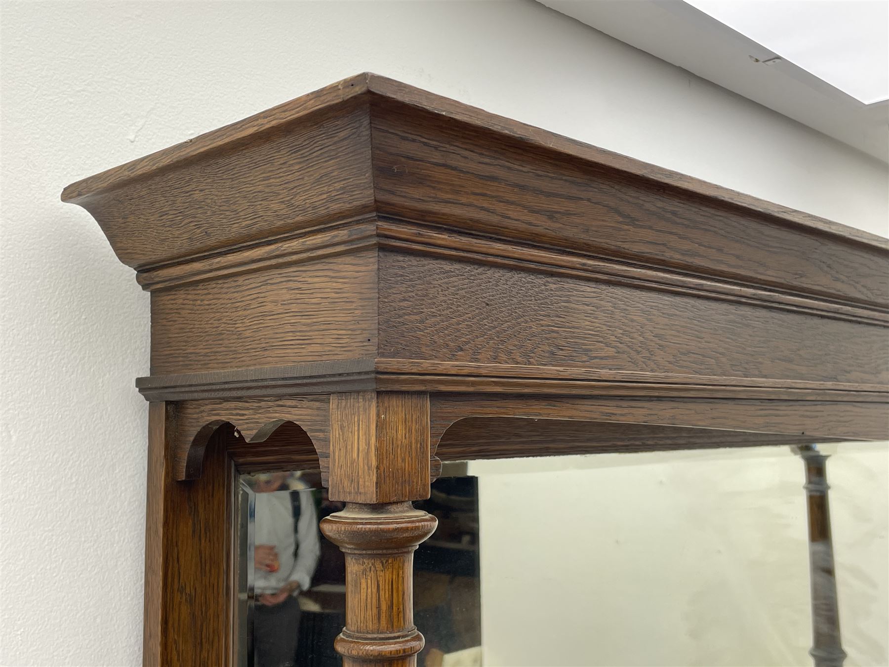 Arts and Crafts period oak mirror back dresser, projecting cornice above rectangular bevelled mirror and shelf, two turned supports, inset copper panel with embossed decoration, rectangular moulded top over two drawers and two panelled cupboard, moulded plinth base, brass and copper strappings and handles 
