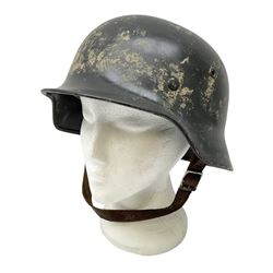 WW2 German steel helmet painted in undecaled Luftwaffe bluey grey with leather liner and chin strap stamped '58', the skirt impressed '1250'
